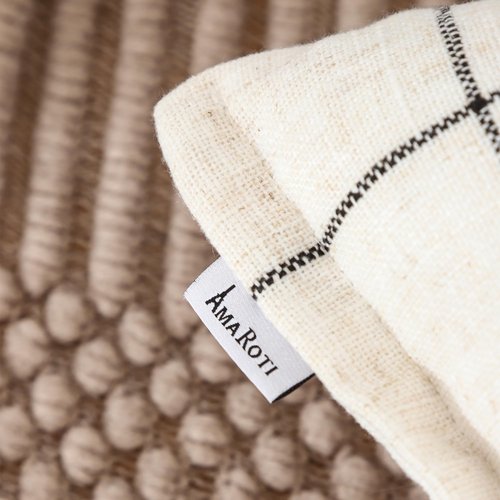 A Striped Pillow in White and Black, with a Bohemian Style. The Back Features a Hidden Zipper Design That resembles an Envelope. Made of Linen. Each Pack Contains Two 20×20-inch Hand-Stitched Edges.